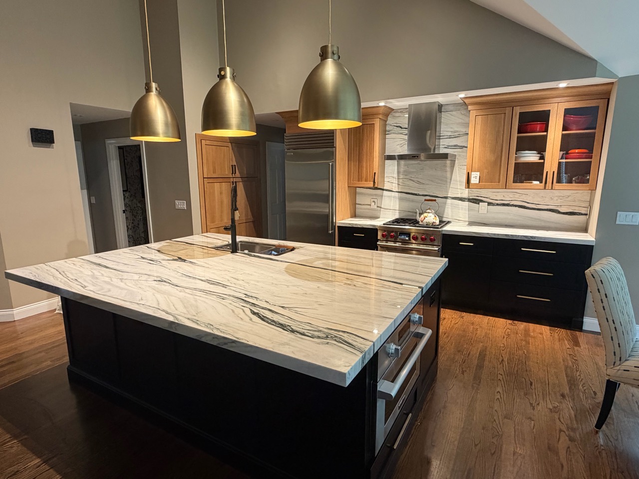 Kitchen island, countertops and full-height backsplash installed by Dream Stoneworks in Marlborough, Massachusetts